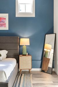 Rattan nightstand and lamp against deep blue