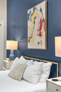 Splash of abstract color above the bed