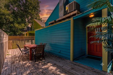 Colorful turquoise exterior w/ a private outdoor seating area — a charming spot to sip & unwind.