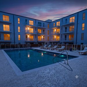 Lounge poolside at the resort-style pool — your own summer escape just steps away.