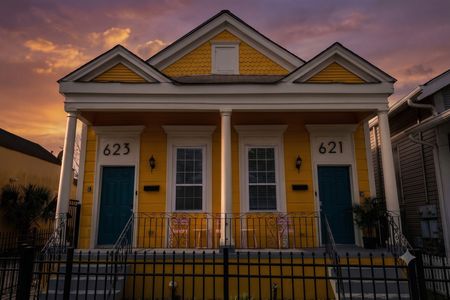 Vibrant yellow & blue historic façade w/ iconic numbered doors — classic charm.