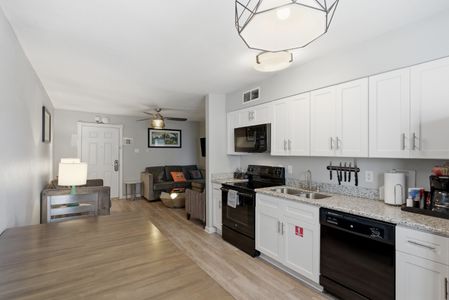 Fully equipped kitchen w/ modern appliances & dining space for meals at home.