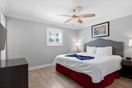 Comfortable king bedroom w/ bold accent bedding & a ceiling fan for cool nights.