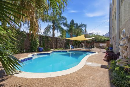 Cool off in the sparkling pool surrounded by lush greenery & shade sails.