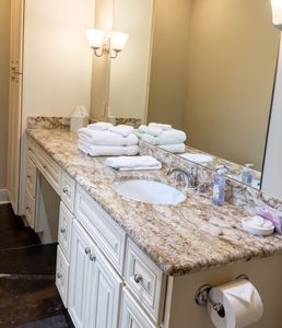 Bright bathroom nook w/ granite counter & vessel sink