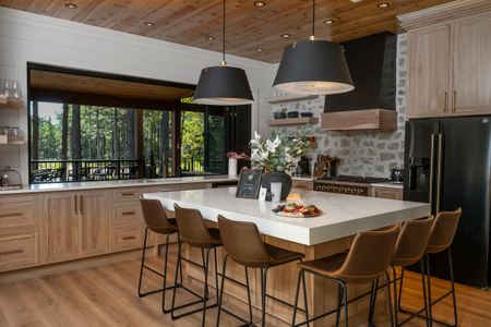 Modern kitchen at Bear Lake Lodge featuring a large island with seating, stylish pendant lights
