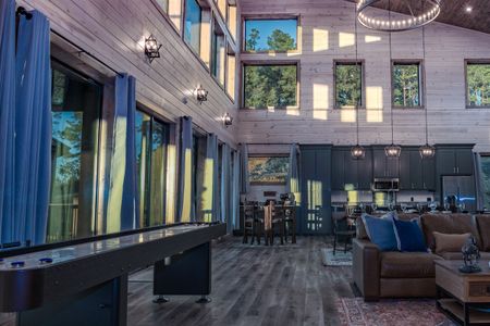 Cabin game room with a pool table and large windows