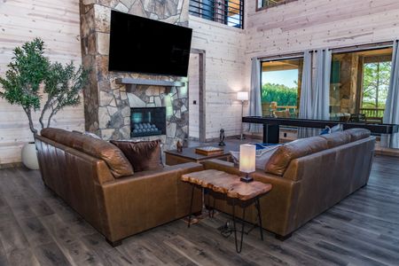 Leather sectional sofa surrounding a wooden coffee table in a cabin