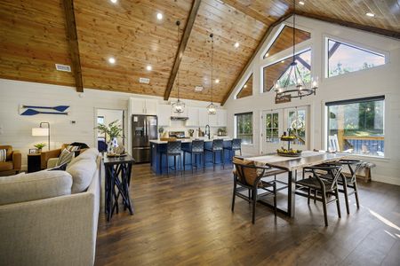 Spacious Bluebird Sky cabin interior showcasing a gourmet kitchen, dining area, and comfortable living room