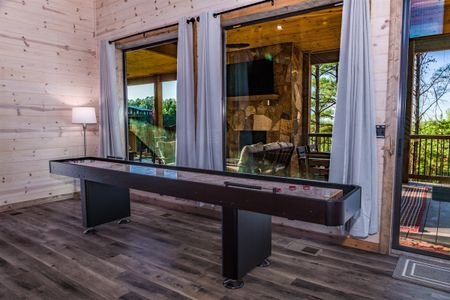 Wooden bench on a cabin deck beside glass doors