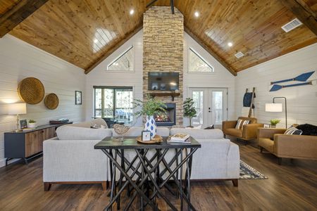 Cozy living room interior of Bluebird Sky cabin featuring a stone fireplace with a mounted