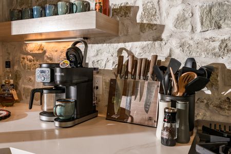 Coffee maker and kitchen utensils on a countertop in Bear Lake Lodge, showcasing the modern