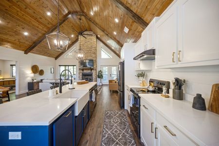 Luxurious kitchen in Bluebird Sky cabin featuring a large island, modern appliances, and a vaulted