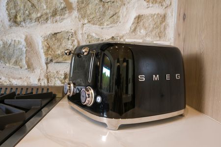 Stylish black SMEG toaster on a kitchen countertop, showcasing the luxury amenities at Bear Lake