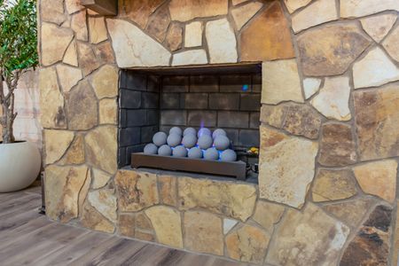 Gas fireplace set into a stone wall