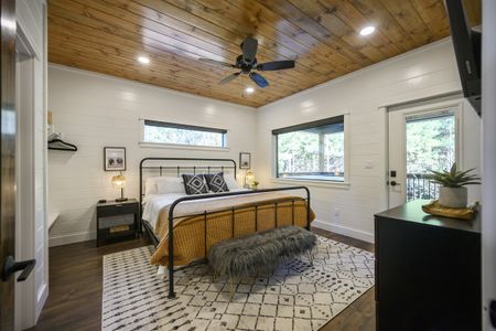 Bright bedroom in Bluebird Sky cabin featuring a queen-size bed, stylish decor, and private patio
