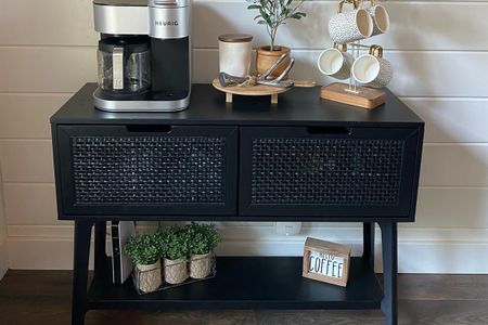 Stylish coffee station with a Keurig, mugs, and decorative accents in a luxury cabin rental