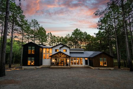 Stunning Bear Lake Lodge retreat in Broken Bow, Oklahoma, featuring modern architecture amidst pine trees