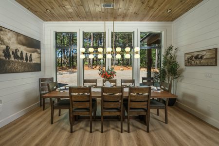 Elegant dining room in Bear Lake Lodge featuring a large wooden table, stylish lighting