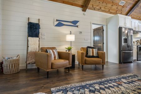 Cozy living room interior of Bluebird Sky cabin featuring two leather armchairs, a patterned rug