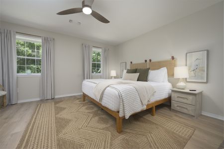 Cozy bedroom featuring a queen-sized bed with white linens, a wooden headboard, and bedside lamps