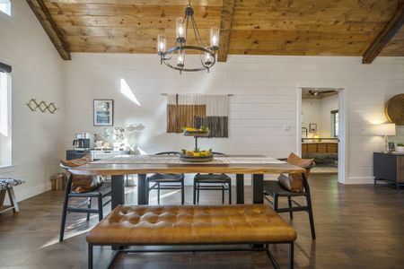 Elegant dining area in a luxury cabin featuring a large wooden table, leather seating