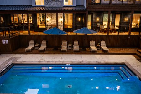 Luxury retreat with a private pool and lounge chairs, nestled among pines at Bear Lake