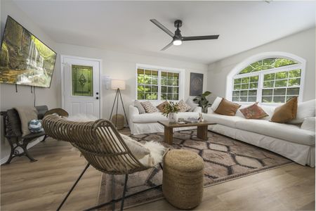 Cozy living room featuring a sectional sofa, decorative pillows, and a coffee table, with large