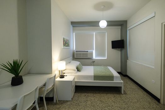 Our room is designed for your convenience, offering a comfortable bed and essential furnishings in a well-organized and inviting layout.