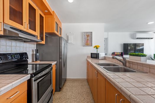 Functional kitchen setup ideal for meal preparation, with all essential appliances and a clean, organized layout.