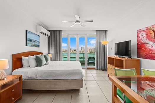 Relax and unwind in this bright studio, where the inviting bed faces large doors opening to an incredible view.