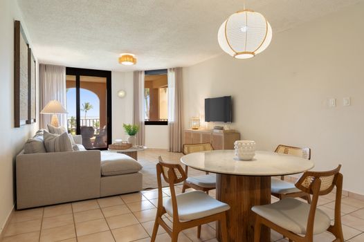 Unwind in our stylish and spacious living room, featuring a comfortable sectional and chic coastal decor.