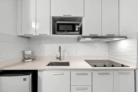 Compact yet complete kitchen with ample storage, ensuring a hassle-free cooking experience.