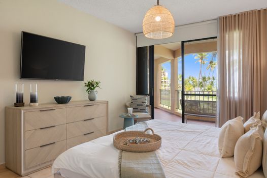 Sleep in style and wake to tropical views! This inviting bedroom offers modern amenities and outdoor access for ultimate relaxation.