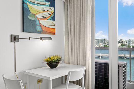 Work or dine comfortably at this well-lit table with captivating water and city views.