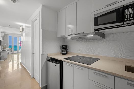 This stylish kitchen offers a contemporary design with practical amenities, making meal prep a breeze. The clean lines and bright finishes create an inviting space.