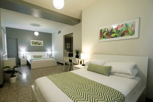 Immerse yourself in a relaxing atmosphere within this stylish bedroom, adorned with subtle artistic touches that create a unique and inviting space.