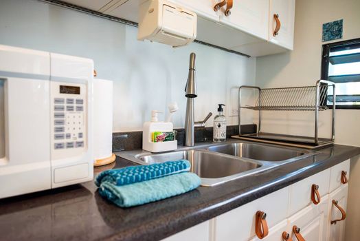 Everything you need for easy meal prep and cleanup is right here. This practical kitchen area includes a microwave, ample sink space, and dish rack.