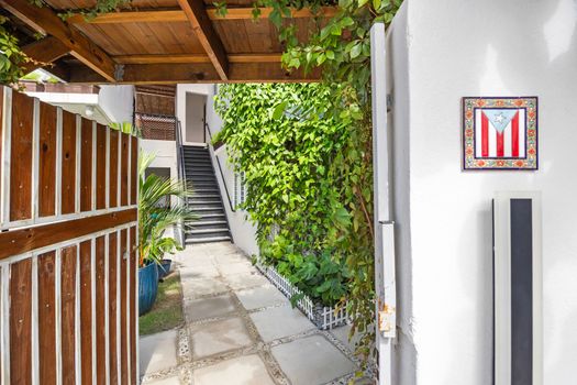 Discover the charming pathway leading to your private retreat, surrounded by lush greenery.