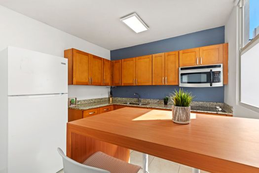 Experience comfort in this spacious kitchen with its inviting breakfast bar, perfect for quick meals or sipping coffee while basking in natural light.