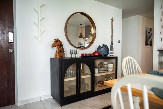 Step into style! Our entryway features a beautiful round mirror, a charming console cabinet with glassware, and unique decorative accents that welcome you to your Malolos retreat.