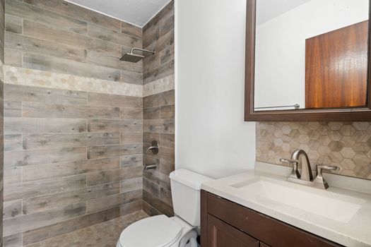 Refresh and rejuvenate! This modern bathroom features a stylish walk-in shower with beautiful tile work and all the essentials for a comfortable start or end to your day."