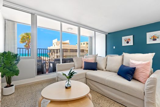 Breezy relaxation is evoked, featuring a mix of natural materials, like bamboo and wicker, and bright, tropical color schemes.
