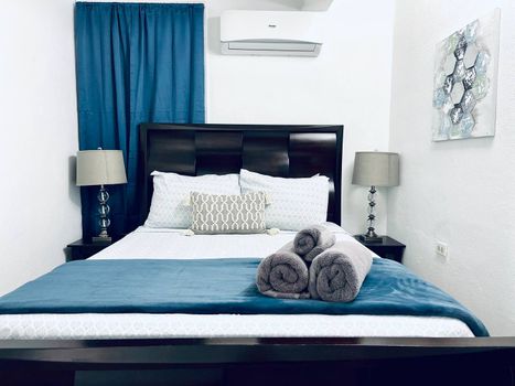 Indulge in ultimate comfort in our serene main bedroom, featuring a luxurious queen-size bed and a Smart TV for your entertainment. Perfect for unwinding after a day of adventures.