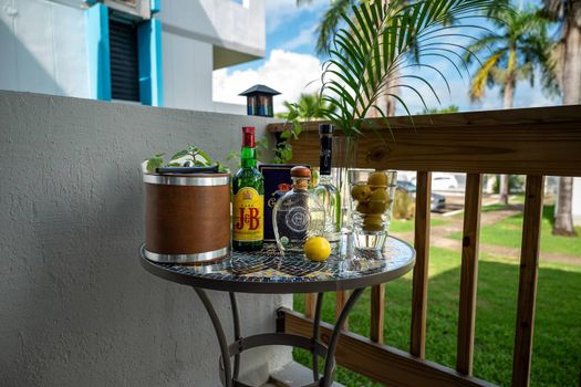 Set the scene for relaxation on your balcony! This cozy table is ready for your favorite drinks, offering a perfect spot to unwind and enjoy the pleasant surroundings.