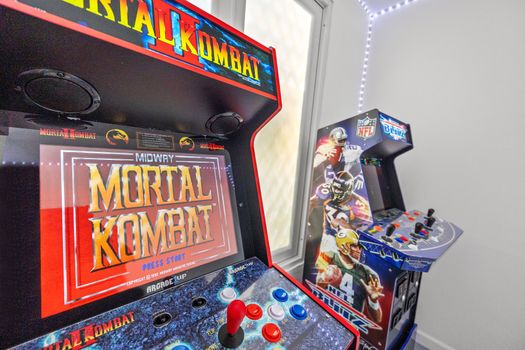 Transform your stay into a gaming adventure with arcade machines and neon lights.