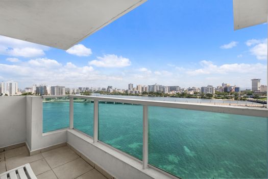 Be captivated by endless turquoise waters stretching to the horizon, with the vibrant city nestled along the shore.