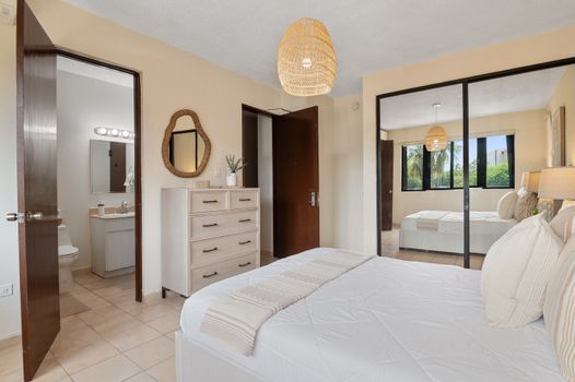 Your serene sanctuary awaits! Enjoy comfort and style in the master bedroom, connecting you to the tropical outdoors.