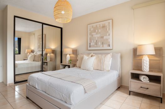Step into comfort and style! This bedroom is a tranquil haven with a comfortable bed and practical amenities.