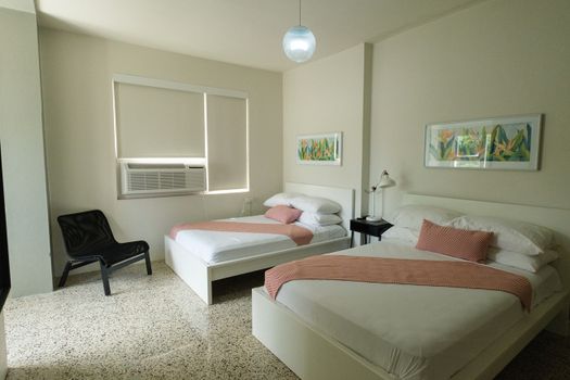 Ideal for friends or family, this room offers two comfortable twin beds, each beautifully made with fresh linens, ensuring a restful night's sleep for everyone.
